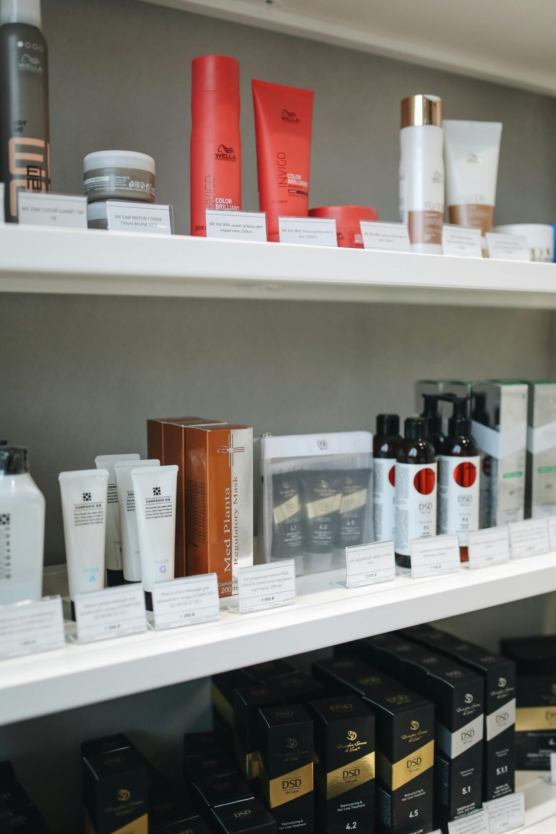 Shelves stocked with assorted self-care and beauty products, including haircare, skincare, and wellness items. Products are neatly arranged in rows with labels visible, showcasing a clean, organized display ideal for home spa or Black Friday shopping inspiration.