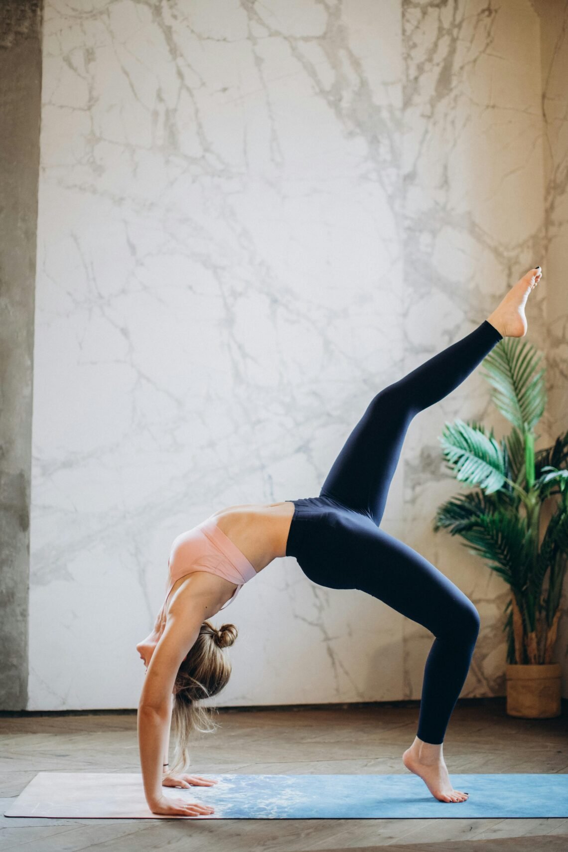 Woman performing a bridge yoga pose at home on a mat, illustrating a luxurious and mindful yoga or stretching routine with Amazon wellness products.
