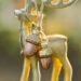 Golden reindeer figurine with glittered acorn ornaments tied in twine, styled in warm natural light, showing a cozy example of simple winter decor ideas to keep up after Christmas.