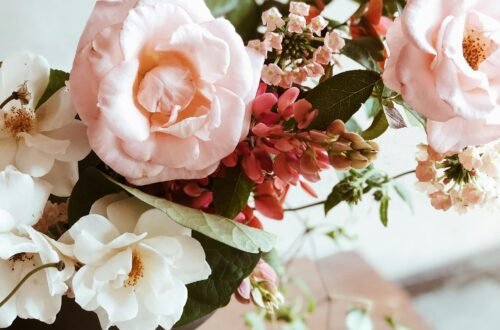 Charming floral arrangement featuring soft pink and white roses in an elegant vase, perfect for romantic occasions.
