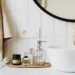 smart bathroom upgrades featuring modern sink with gold faucet neutral soap dispenser towel and minimalist bathroom accessories for a clean safe bathroom