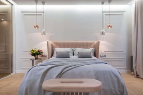 Luxury hotel inspired bedroom featuring a soft upholstered bed, warm pendant lighting, neutral decor, and calming Amazon bedroom finds for a cozy, elegant space